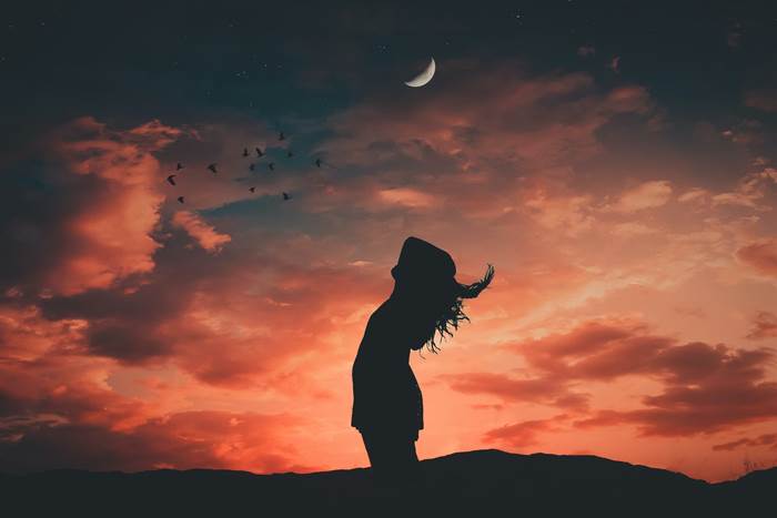 Девушка на фоне растущей луны ночью